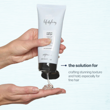 Load image into Gallery viewer, Hand holding a tube of hair gel milk_shake 'lifestyling' with text about its use.