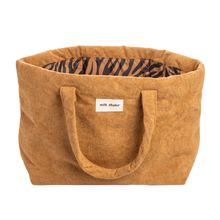 Load image into Gallery viewer, Brown tote bag with a zebra pattern interior and 'milk shake' label on a white background