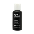 Black shampoo bottle with white cap labeled 'milk shake icy blond' on a white background