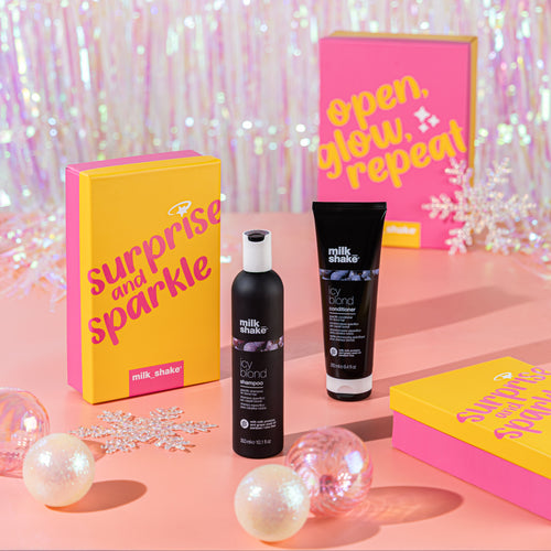 Cosmetic products with 'Surprise and Sparkle' packaging on a pink background