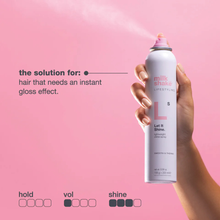 Load image into Gallery viewer, Hand holding a can of milk_shake let it shine spray against a pink background
