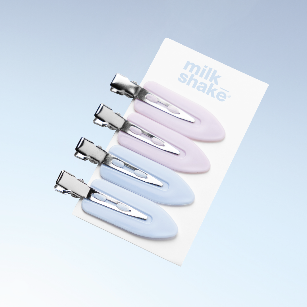 Set of four pastel-coloured hair clips on a 'milk shake' branded card against a light blue background.