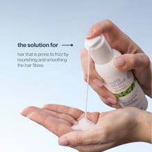 Load image into Gallery viewer, Hand holding a bottle of 'milk shake no frizz allowed' glistening serum with liquid being poured onto a palm against a light blue background.

